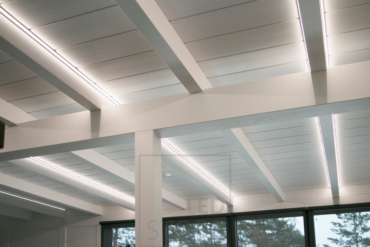 LED strips highlighting the beams, also creating good and high quality lighting in the space.